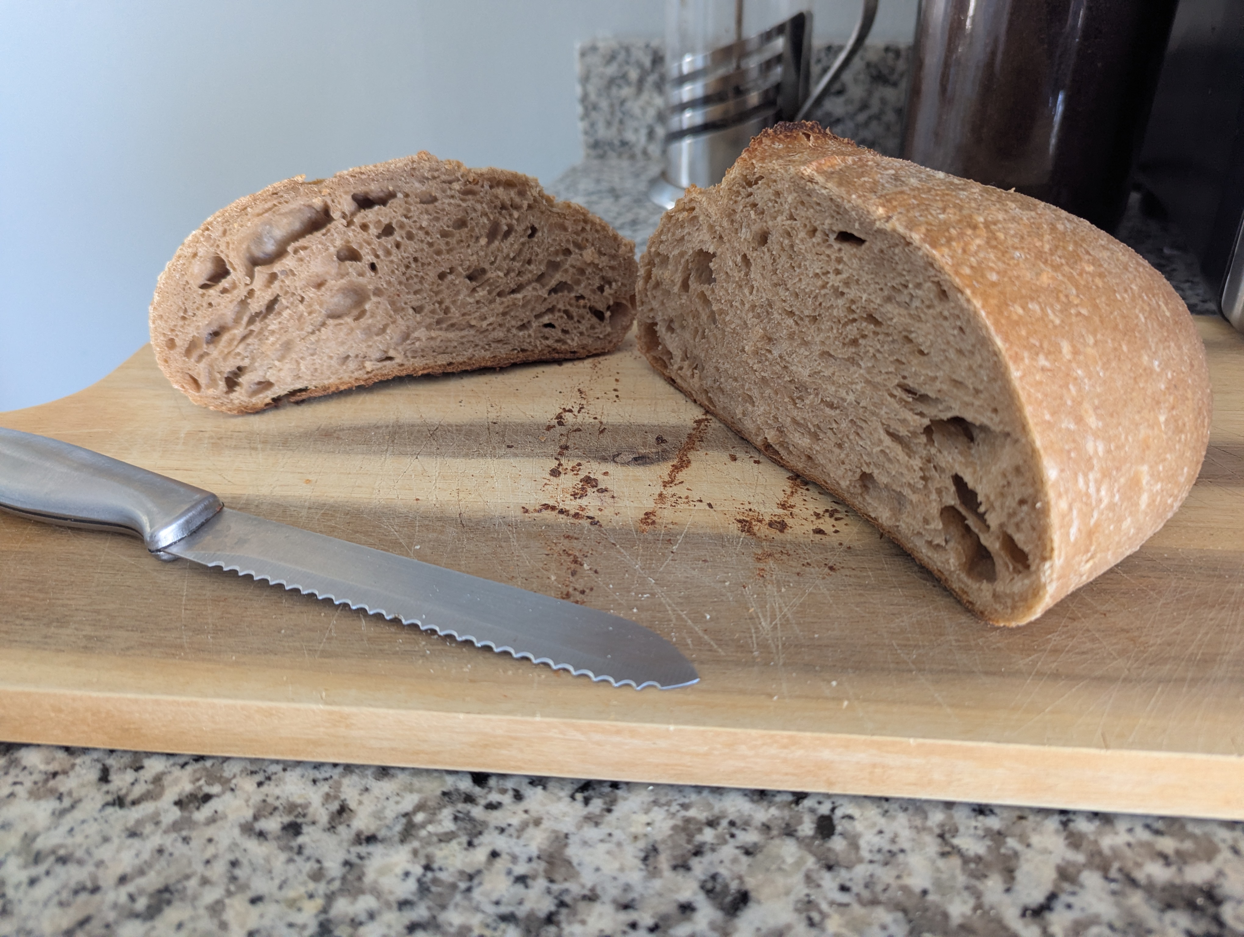 Fresh sourdough loaf cut open showing open crumb, artisan bread Dover NH