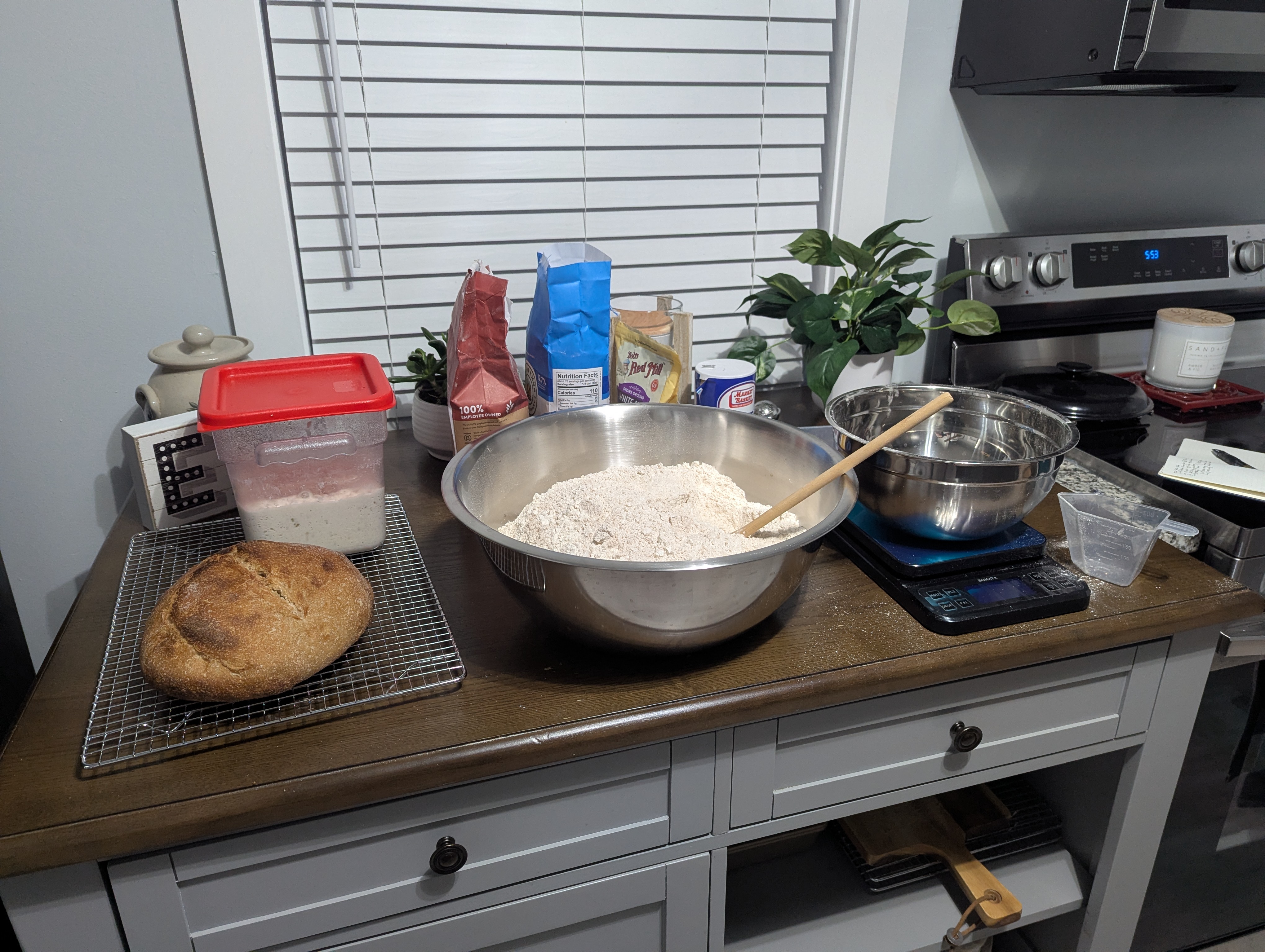 Fresh bread, sourdough starter, and flour